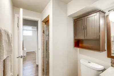 a bathroom with a toilet and a cabinet at 8 Mi to Dtwn Denver Haven with Patio and Yard! in Denver