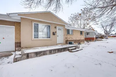 a house with snow on the ground in front of it at 8 Mi to Dtwn Denver Haven with Patio and Yard! in Denver