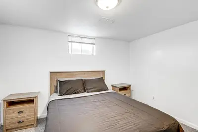 a bedroom with a large bed and two night stands at 8 Mi to Dtwn Denver Haven with Patio and Yard! in Denver