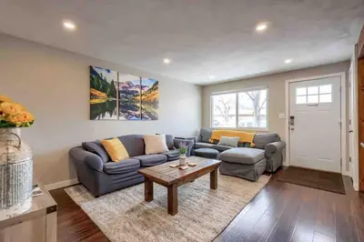 a living room with a couch and a table at 4BR Longmont Escape with Cold Plunge & Sauna - Pets OK! in Longmont