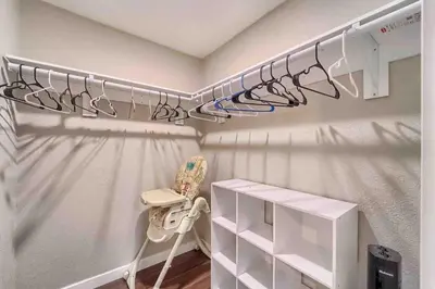 a walk in closet with a crib and a chair at 4BR Longmont Escape with Cold Plunge & Sauna - Pets OK! in Longmont