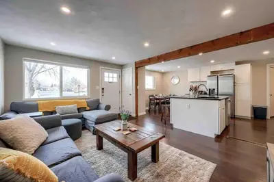 a living room with a couch and a table at 4BR Longmont Escape with Cold Plunge & Sauna - Pets OK! in Longmont