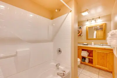 a bathroom with a tub and a toilet and a sink at 3 Mi to Rocky Mtn National Park Estes Park Cabin! in Estes Park
