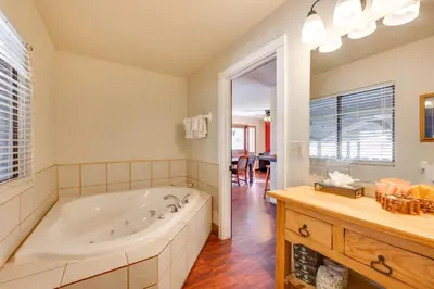 a large bathroom with a tub and a table at 3 Mi to Rocky Mtn National Park Estes Park Cabin! in Estes Park
