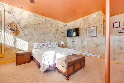 a bedroom with a bed and a wall with a mural at 3 Mi to Rocky Mtn National Park Estes Park Cabin! in Estes Park