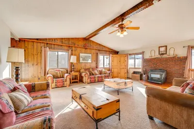 a living room with a couch and a table at 3 Mi to Rocky Mtn National Park Estes Park Cabin! in Estes Park