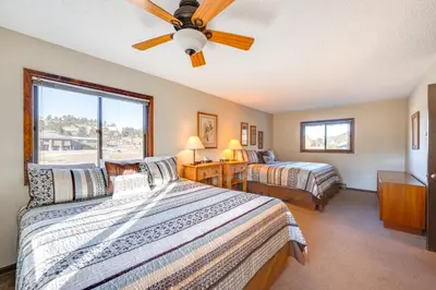 a bedroom with two beds and a ceiling fan at 3 Mi to Rocky Mtn National Park Estes Park Cabin! in Estes Park