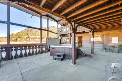 a large building with a bath tub on a patio at 3 Mi to Rocky Mtn National Park Estes Park Cabin! in Estes Park