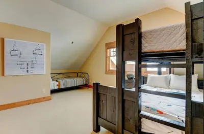 a room with two bunk beds and a bedroom at Luxe Winter Park Escape - 5BR with Hot Tub & Game Room in Winter Park