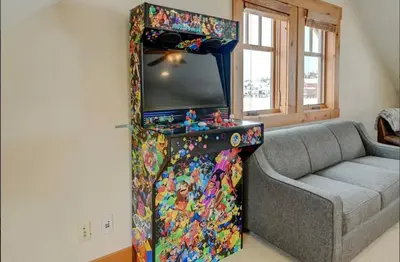 a living room with a tv and a couch at Luxe Winter Park Escape - 5BR with Hot Tub & Game Room in Winter Park