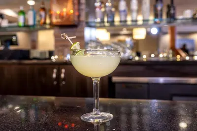 a drink in a glass sitting on a counter in a bar at Holiday Inn Frisco by IHG in Frisco