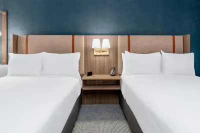 two beds sitting next to each other in a room at Holiday Inn Frisco by IHG in Frisco