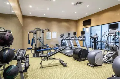 a gym with several treadmills and elliptical machines at Holiday Inn Frisco by IHG in Frisco