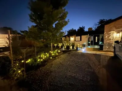 a garden lit up at night with christmas lights at Pickleball and Hot Tub Retreat in Denver