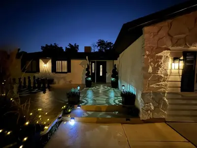 a house with a courtyard at night with lights at Pickleball and Hot Tub Retreat in Denver