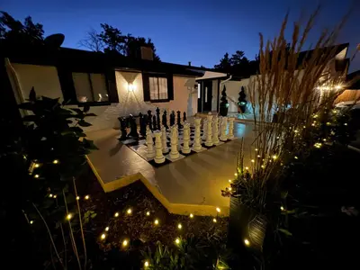 a large chess game in the yard of a house at night at Pickleball and Hot Tub Retreat in Denver