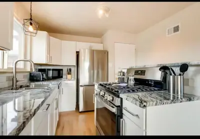 a kitchen with a stove and a stainless steel refrigerator at Cherry Creek Colorado in Denver