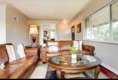 a living room with leather couches and a table at Cherry Creek Colorado in Denver