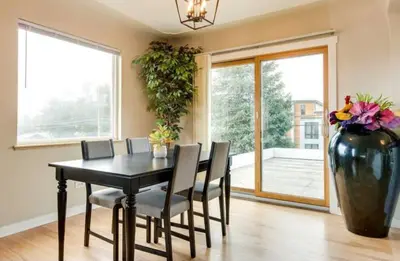 a dining room with a black table and a large vase at Cherry Creek Colorado in Denver
