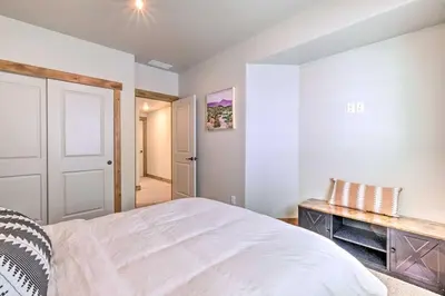 a bedroom with a white bed and a table at Quiet Family Friendly 3 BR Near Loveland DT in Loveland