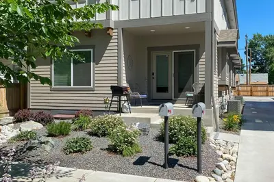 a house with two parking meters in front of a yard at Quiet Family Friendly 3 BR Near Loveland DT in Loveland