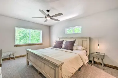 a bedroom with a bed and a ceiling fan at Quiet Family Friendly 3 BR Near Loveland DT in Loveland