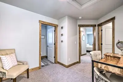 a living room with a chair and a table at Quiet Family Friendly 3 BR Near Loveland DT in Loveland