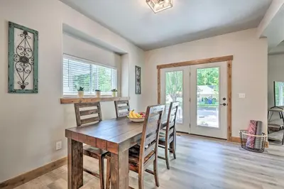 a dining room with a wooden table and chairs at Quiet Family Friendly 3 BR Near Loveland DT in Loveland