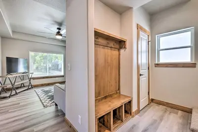 a living room with a sliding barn door and a table at Quiet Family Friendly 3 BR Near Loveland DT in Loveland