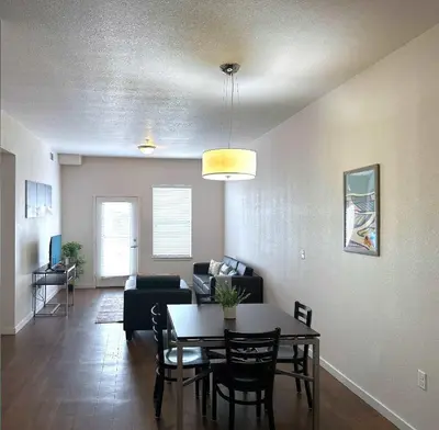 a living room with a table and a couch at Welcoming Hideaway Near UNC & Downtown in Greeley