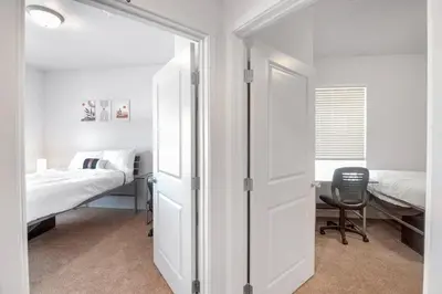 a bedroom with a bed and a desk with a chair at Welcoming Hideaway Near UNC & Downtown in Greeley