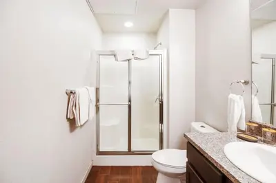 a bathroom with a shower and a toilet and a sink at Central Urban Stay with Gym in Greeley