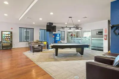 a living room with a pool table in it at Central Urban Stay with Gym in Greeley