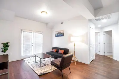 a living room with a couch and a table at Central Urban Stay with Gym in Greeley