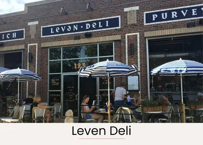 people sitting at tables in front of a store with umbrellas at Stylish City Loft Walk to Dining & Shops in Denver