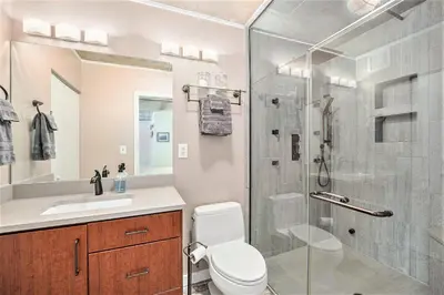 a bathroom with a shower and a toilet and a sink at Stylish City Loft Walk to Dining & Shops in Denver
