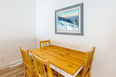 a dining room table with chairs and a picture on the wall at Tabernash Escape in Tabernash
