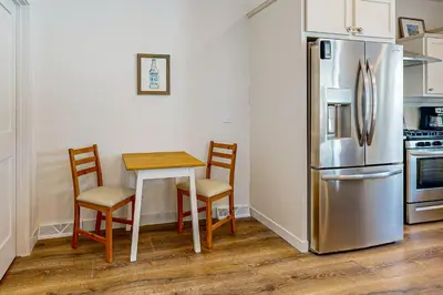 a kitchen with a table and a refrigerator at Tabernash Escape in Tabernash