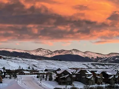 a group of houses in the snow with mountains at Tabernash Escape in Tabernash