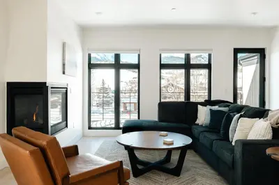 a living room with a couch and a table at Chic Silverthorne Condo with Rocky MTN Vista Views in Silverthorne