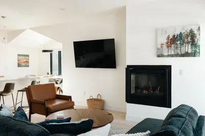 a living room with a couch and a fireplace at Chic Silverthorne Condo with Rocky MTN Vista Views in Silverthorne