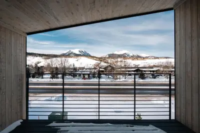 a window with a view of snow covered mountains at Chic Silverthorne Condo with Rocky MTN Vista Views in Silverthorne
