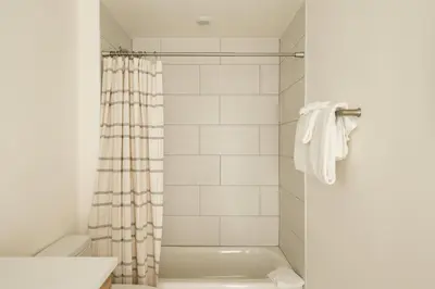 a bathroom with a tub and a shower curtain at Chic Silverthorne Condo with Rocky MTN Vista Views in Silverthorne
