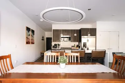 a dining room and kitchen with a table and chairs at Riverfront Patio - Hot Tub - Luxe Silverthorne in Silverthorne