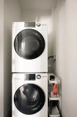 a washer and a dryer in a room at Riverfront Patio - Hot Tub - Luxe Silverthorne in Silverthorne