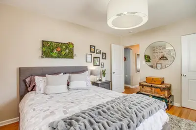 a bedroom with a large bed in a room at Walk to City Park Chic Home with Hot Tub and Yard in Denver