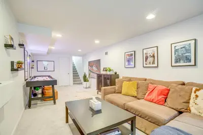 a living room with a couch and a table at Walk to City Park Chic Home with Hot Tub and Yard in Denver