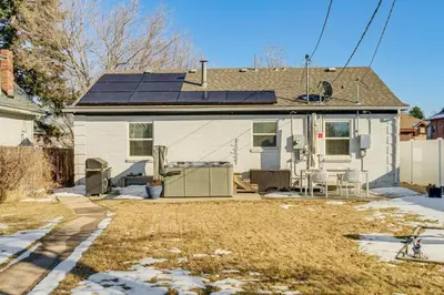 a house with solar panels on the roof at Walk to City Park Chic Home with Hot Tub and Yard in Denver