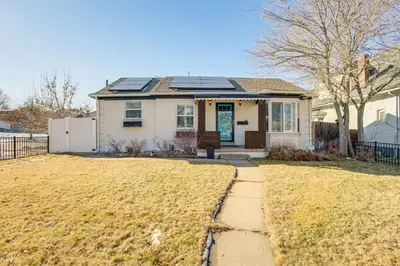 a house with solar panels on the roof at Walk to City Park Chic Home with Hot Tub and Yard in Denver