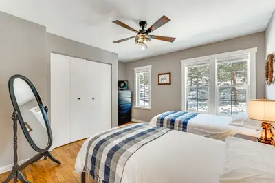a bedroom with two beds and a ceiling fan at Steps to Estes Lake Mtn-View Hideaway with Hot Tub! in Estes Park